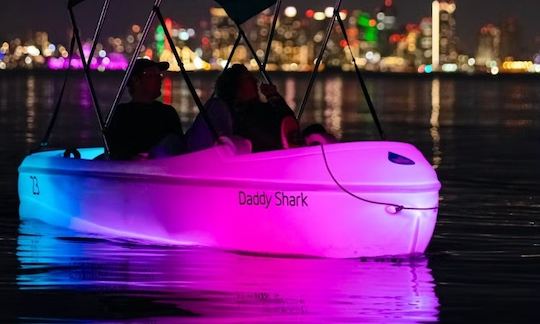 Night water activity on Point Loma. Cruise in San Diego Bay on Glowing pedal boat with a disco ball and a speaker