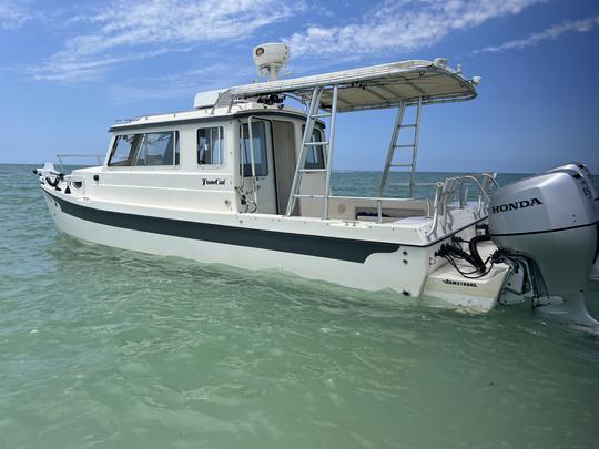 Catamaran à cabine de 26 pieds piloté par Scott Guttery, originaire de la SWFL