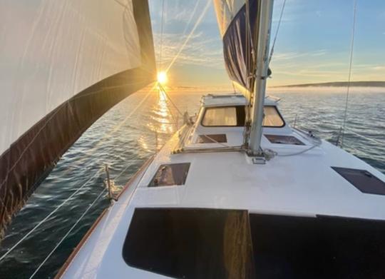 Sailing with Dolphins at Sunset on 35ft Legacy Catamaran