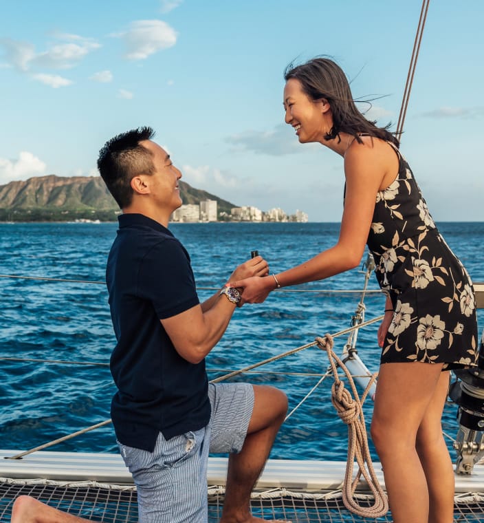 A man proposing to his girlfriend on a boat.